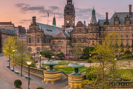 A view of the town hall from the Peace Garden at dusk